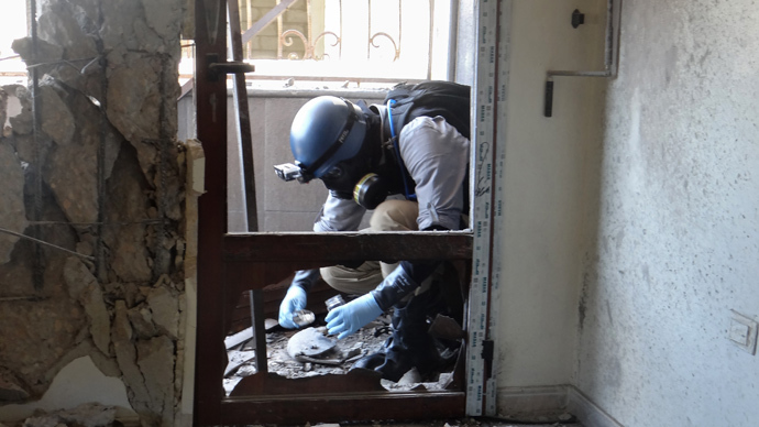 A United Nations (UN) arms expert collects samples on August 29, 2013, as they inspect the site where rockets had fallen in Damascus' eastern Ghouta suburb during an investigation into a suspected chemical weapons strike near the capital. (AFP Photo / Ammar Al-Arbini) 